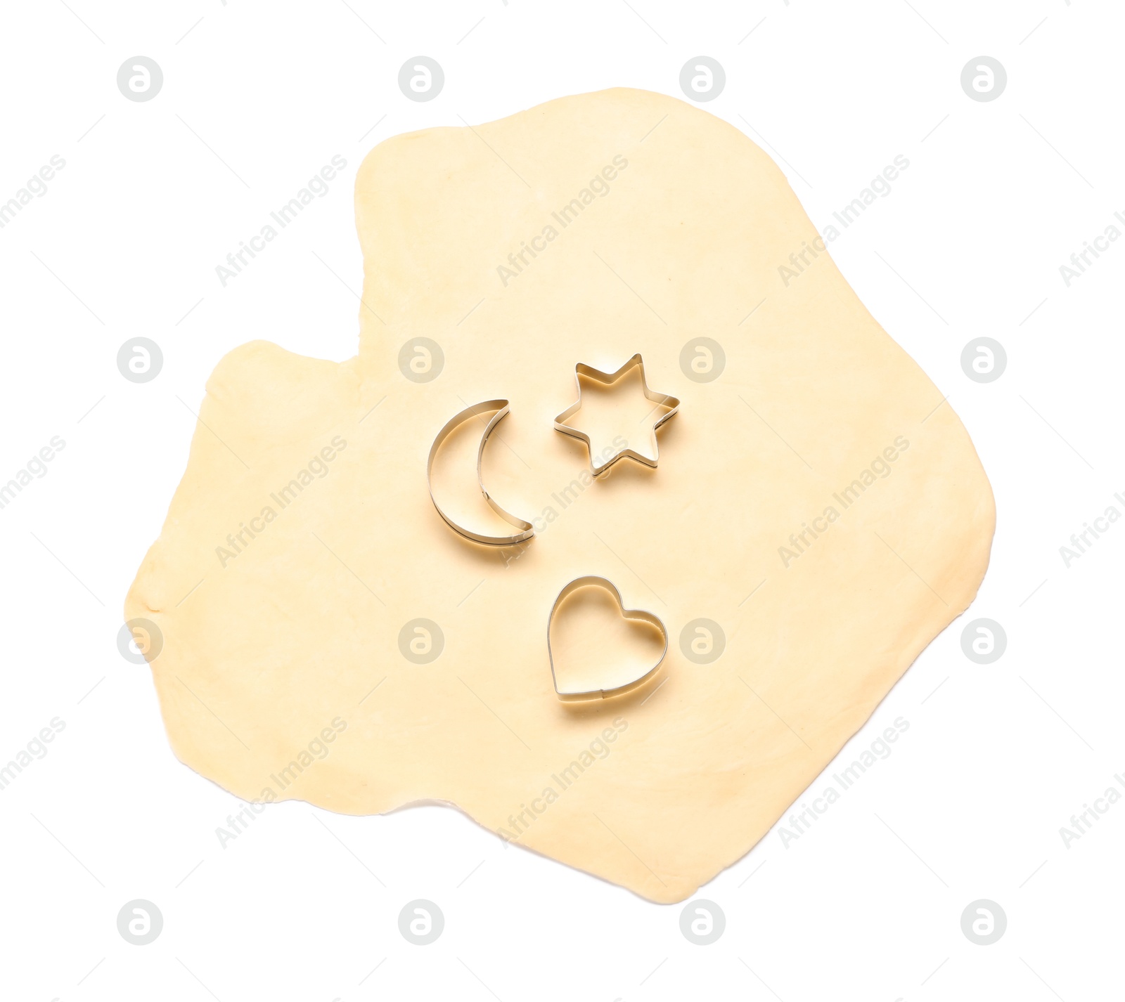 Photo of Raw dough and cookie cutters isolated on white, top view