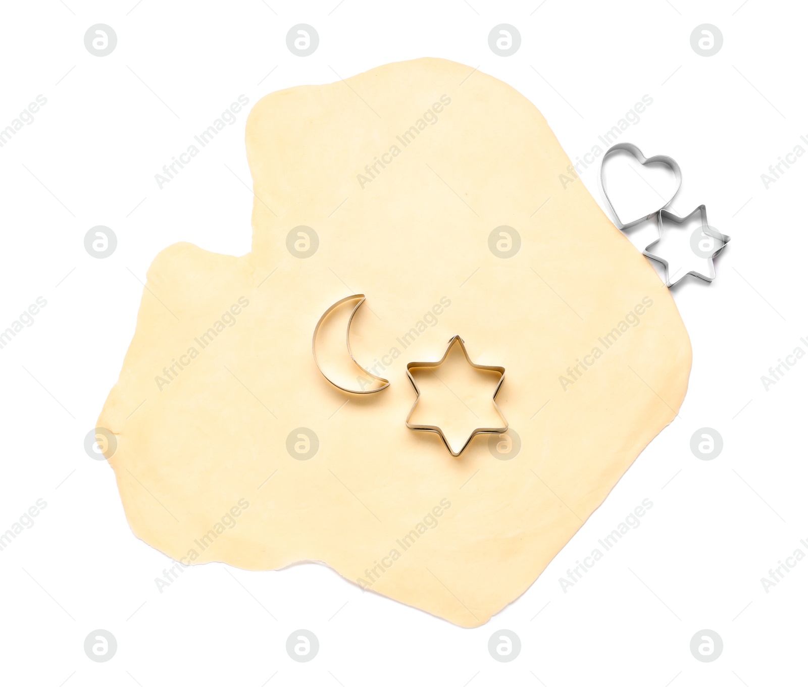 Photo of Raw dough and cookie cutters isolated on white, top view