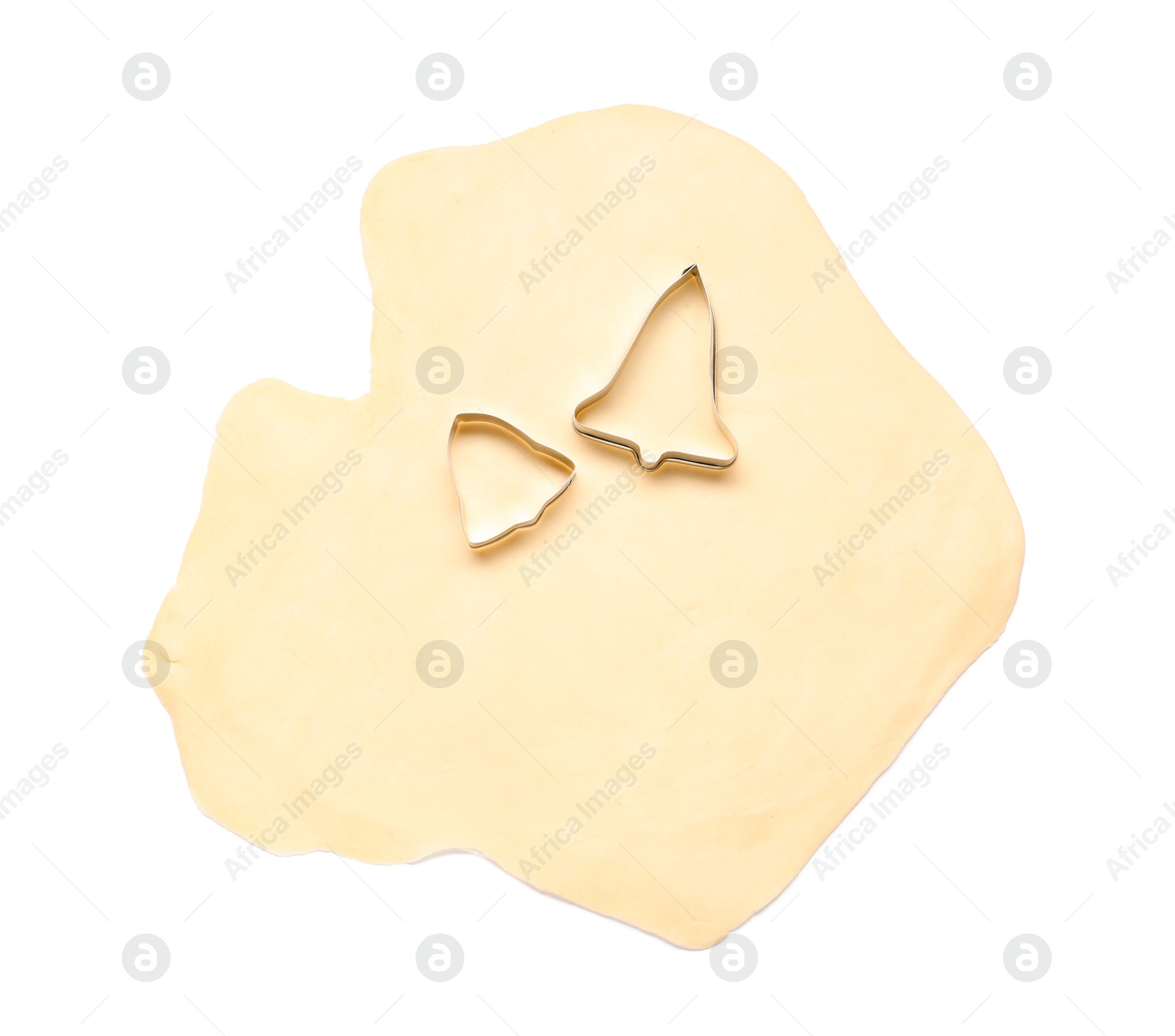 Photo of Raw dough and cookie cutters isolated on white, top view