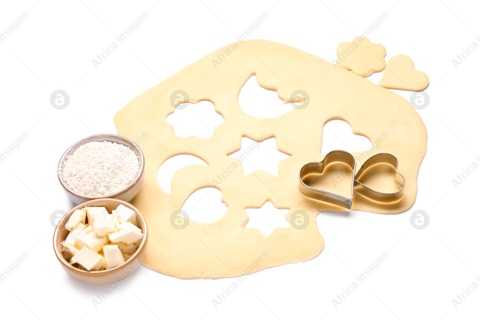 Photo of Raw dough, flour, butter and cookie cutters isolated on white