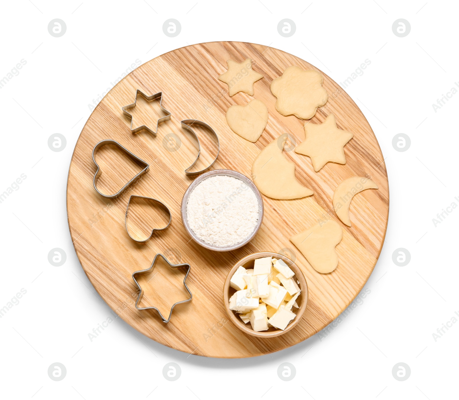 Photo of Raw dough, cookie cutters, flour and butter isolated on white, top view