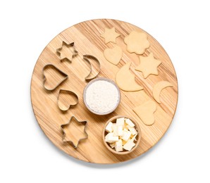 Photo of Raw dough, cookie cutters, flour and butter isolated on white, top view