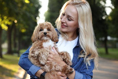 Photo of Beautiful young woman with cute dog in park