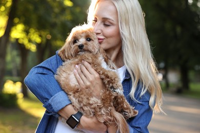 Photo of Beautiful young woman with cute dog in park