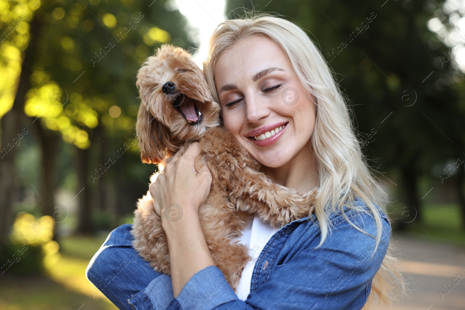 Photo of Beautiful young woman with cute dog in park