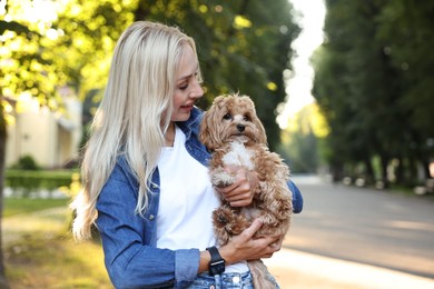 Photo of Beautiful young woman with cute dog in park