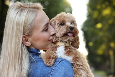 Photo of Beautiful young woman with cute dog in park