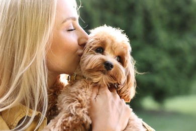 Photo of Beautiful young woman with cute dog in park