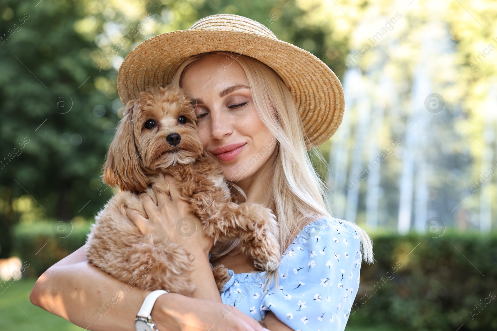 Photo of Beautiful young woman with cute dog in park