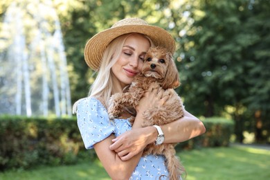 Photo of Beautiful young woman with cute dog in park