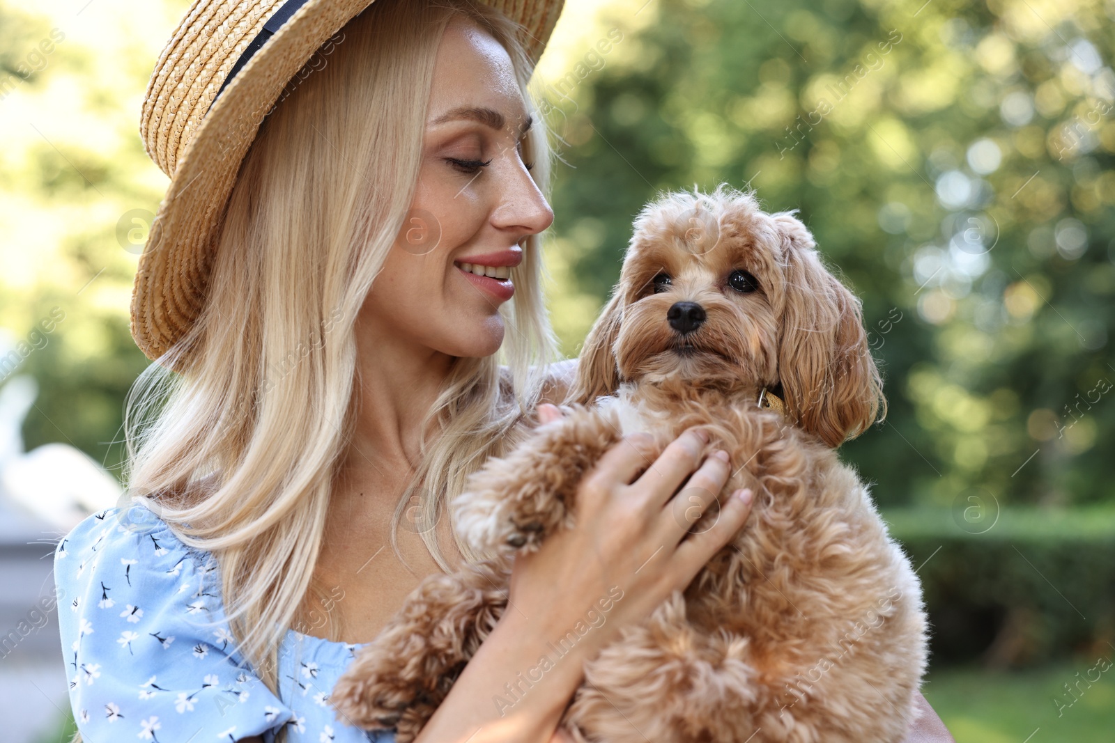 Photo of Beautiful young woman with cute dog in park