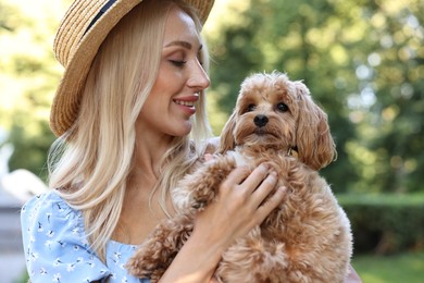 Photo of Beautiful young woman with cute dog in park