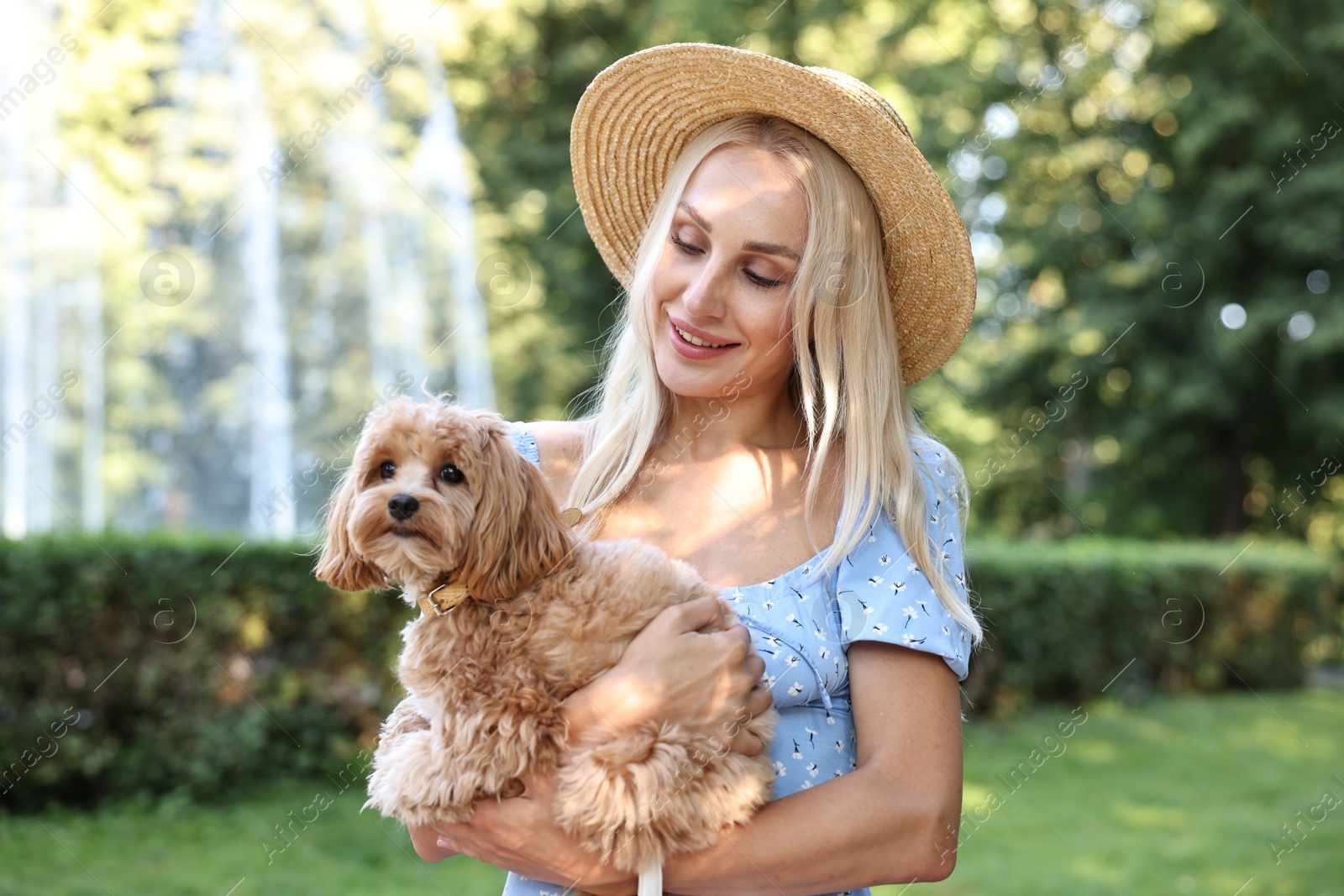 Photo of Beautiful young woman with cute dog in park