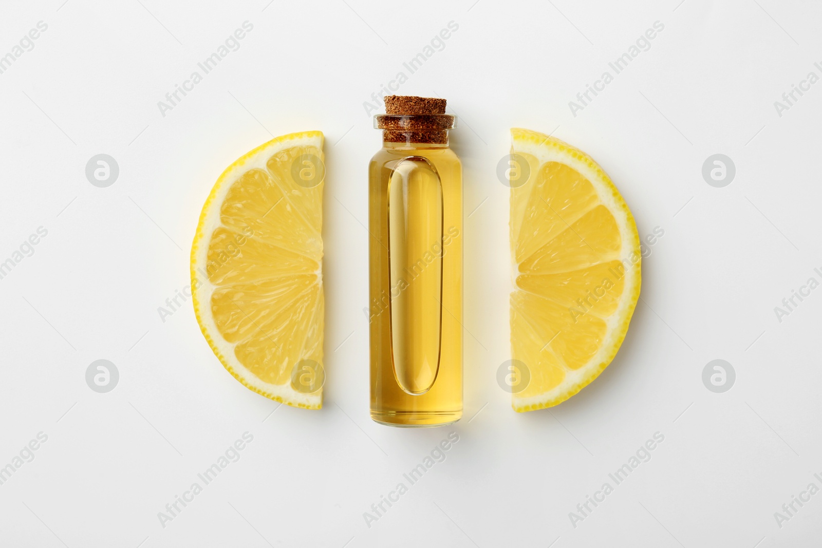 Photo of Bottle of essential oil and lemon on white background, top view