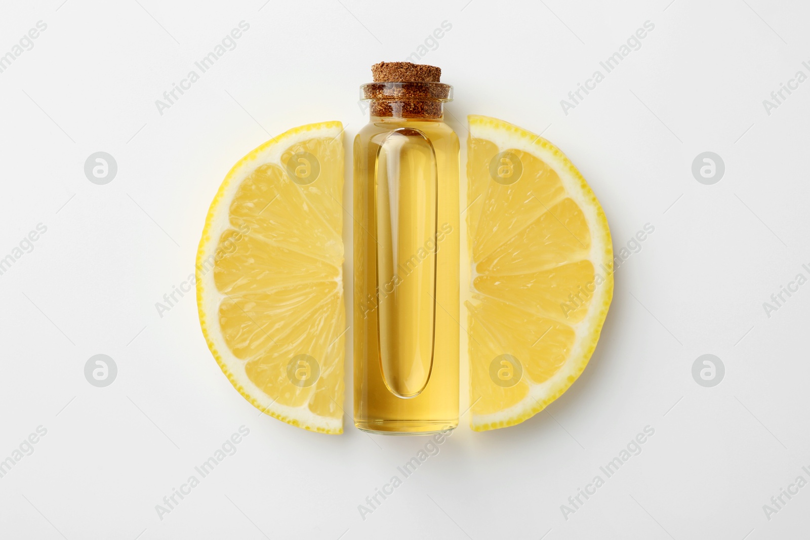 Photo of Bottle of essential oil and lemon on white background, top view