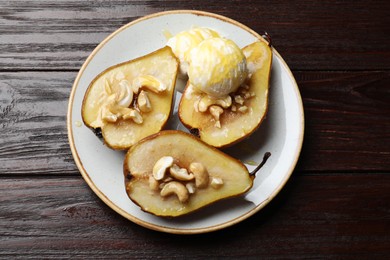 Photo of Delicious baked pears with nuts, ice cream and honey on wooden table, top view