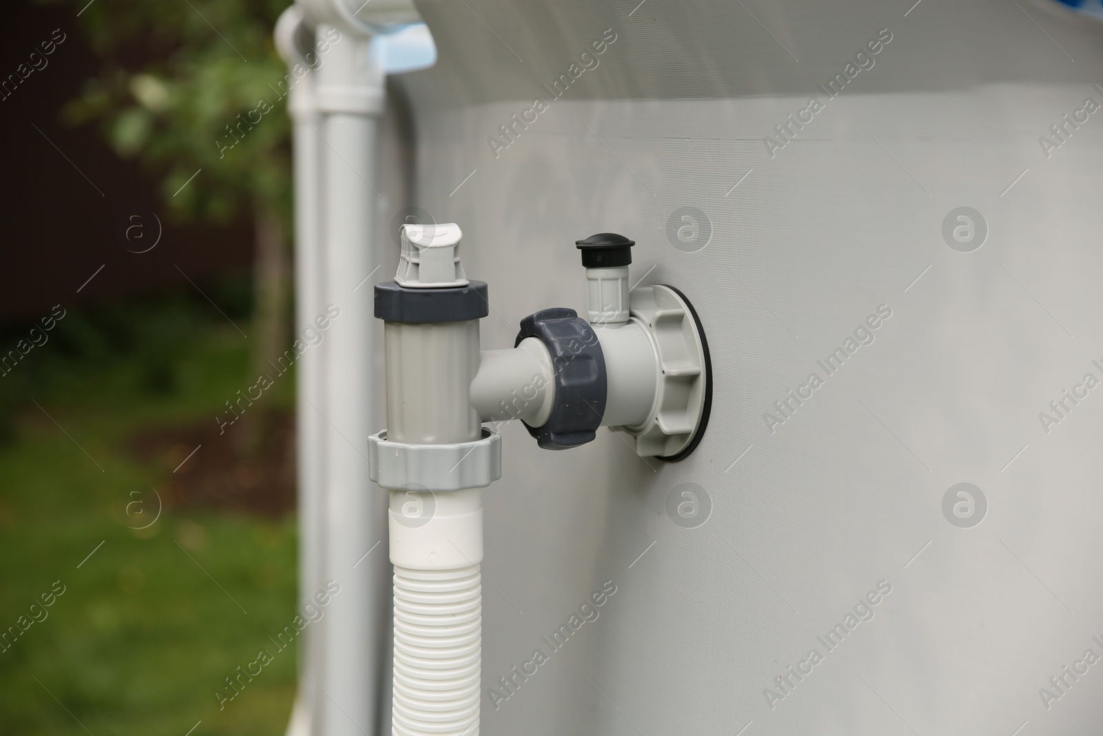 Photo of Above ground swimming pool with skimmer in garden, closeup