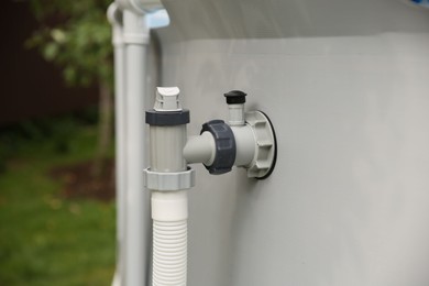 Photo of Above ground swimming pool with skimmer in garden, closeup