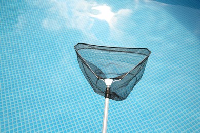 Photo of One skimmer net and swimming pool, above view