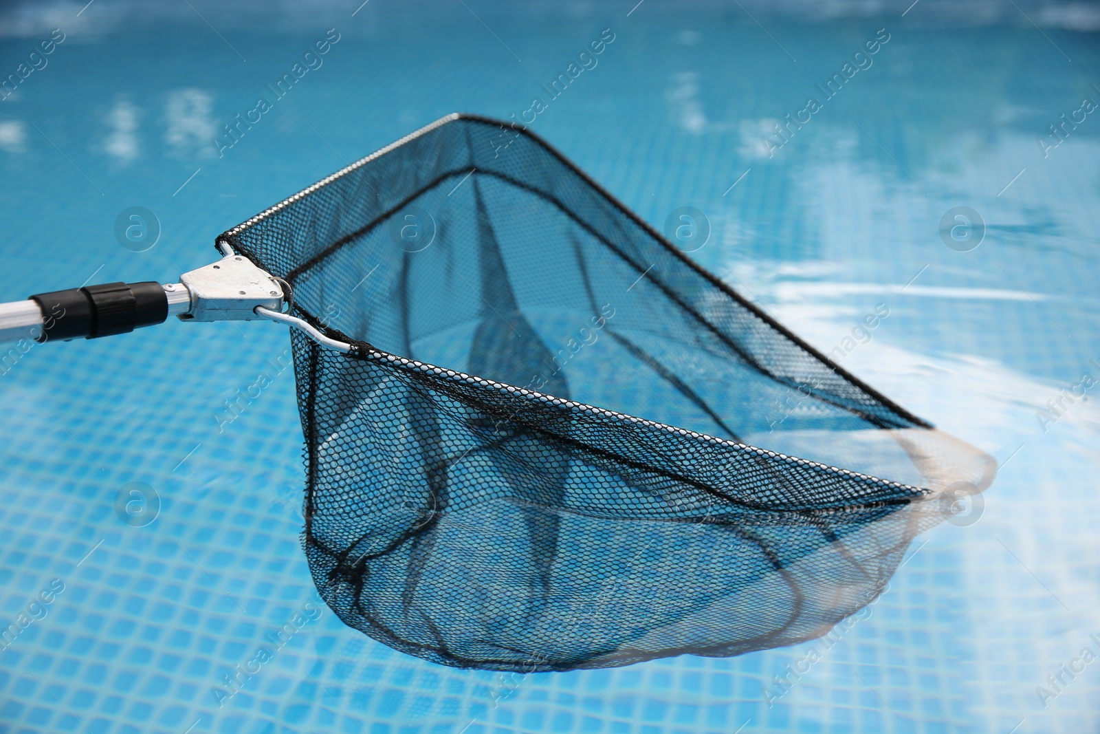 Photo of One skimmer net above swimming pool, closeup