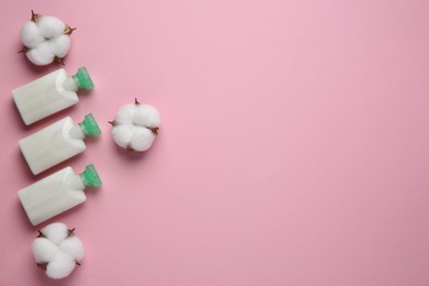 Photo of Different cosmetic products and cotton flowers on pink background, flat lay. Space for text