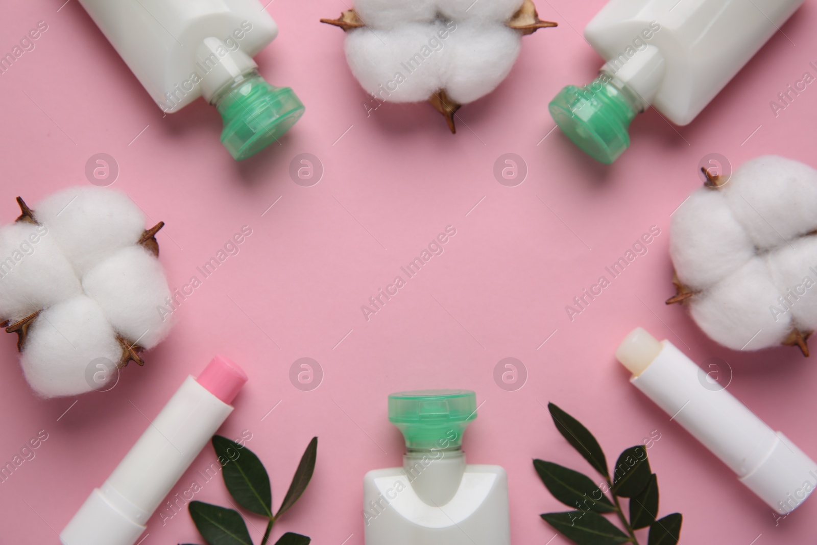 Photo of Different cosmetic products, leaves and cotton flowers on pink background, flat lay. Space for text