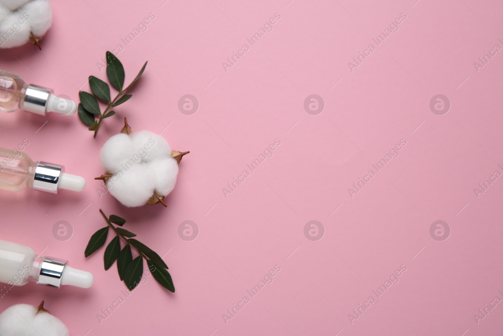 Photo of Different cosmetic products, leaves and cotton flowers on pink background, flat lay. Space for text