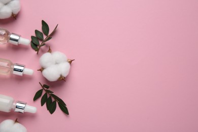 Photo of Different cosmetic products, leaves and cotton flowers on pink background, flat lay. Space for text