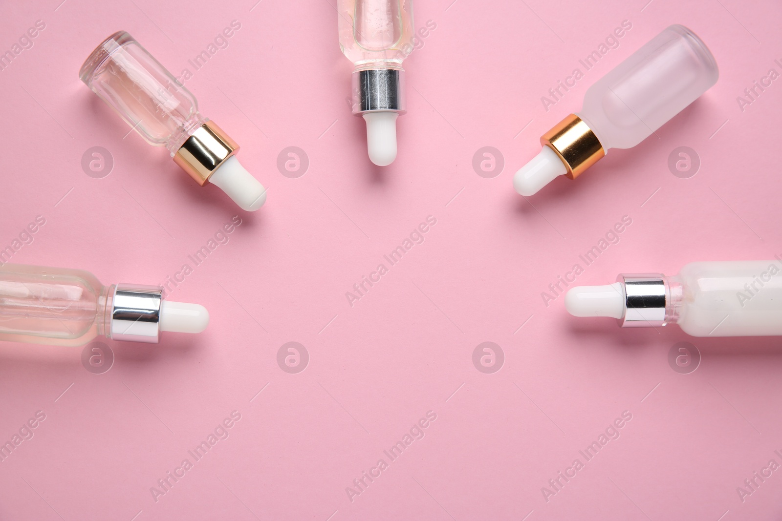 Photo of Different cosmetic products on pink background, flat lay. Space for text