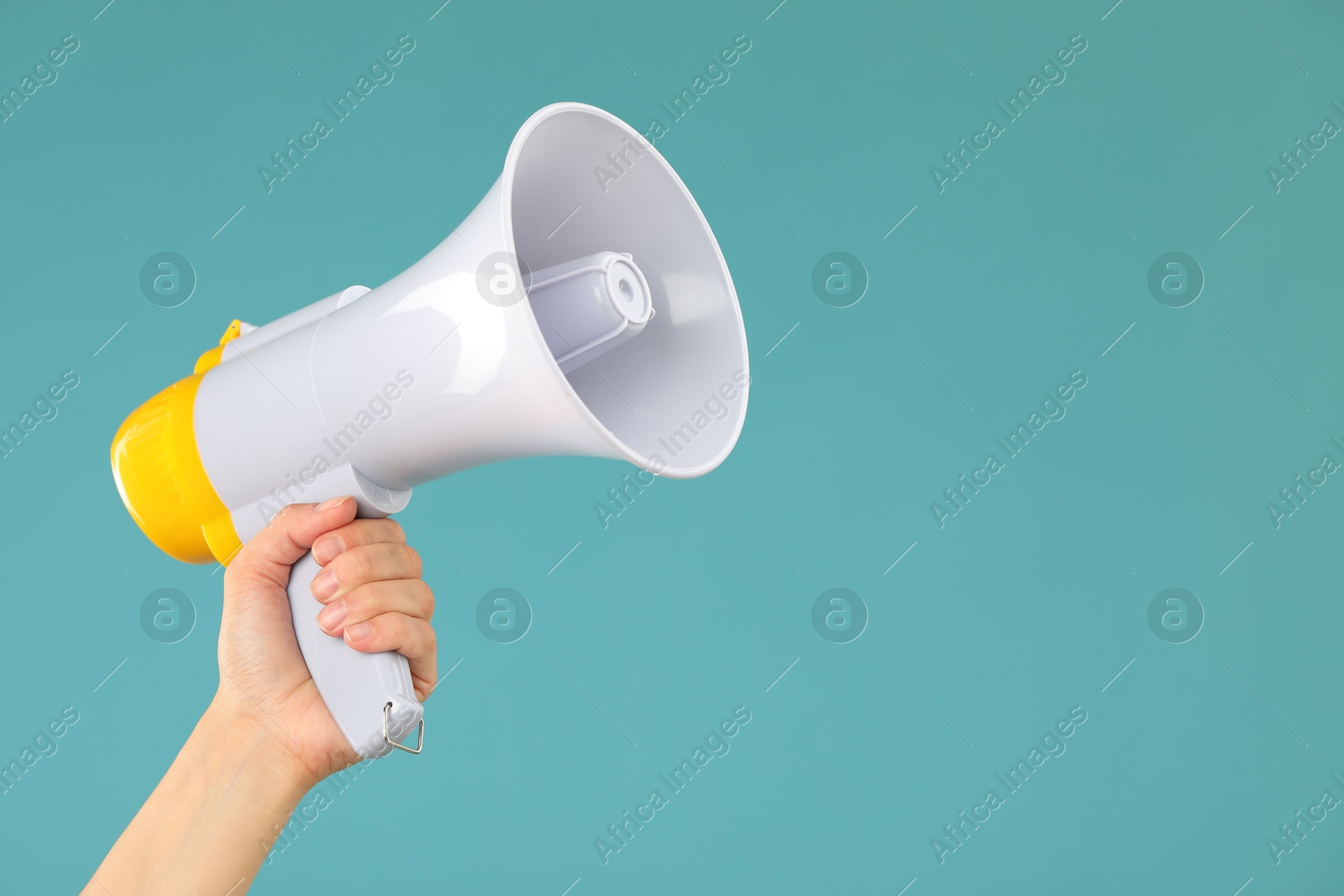 Photo of Woman holding megaphone speaker on blue background, closeup. Space for text