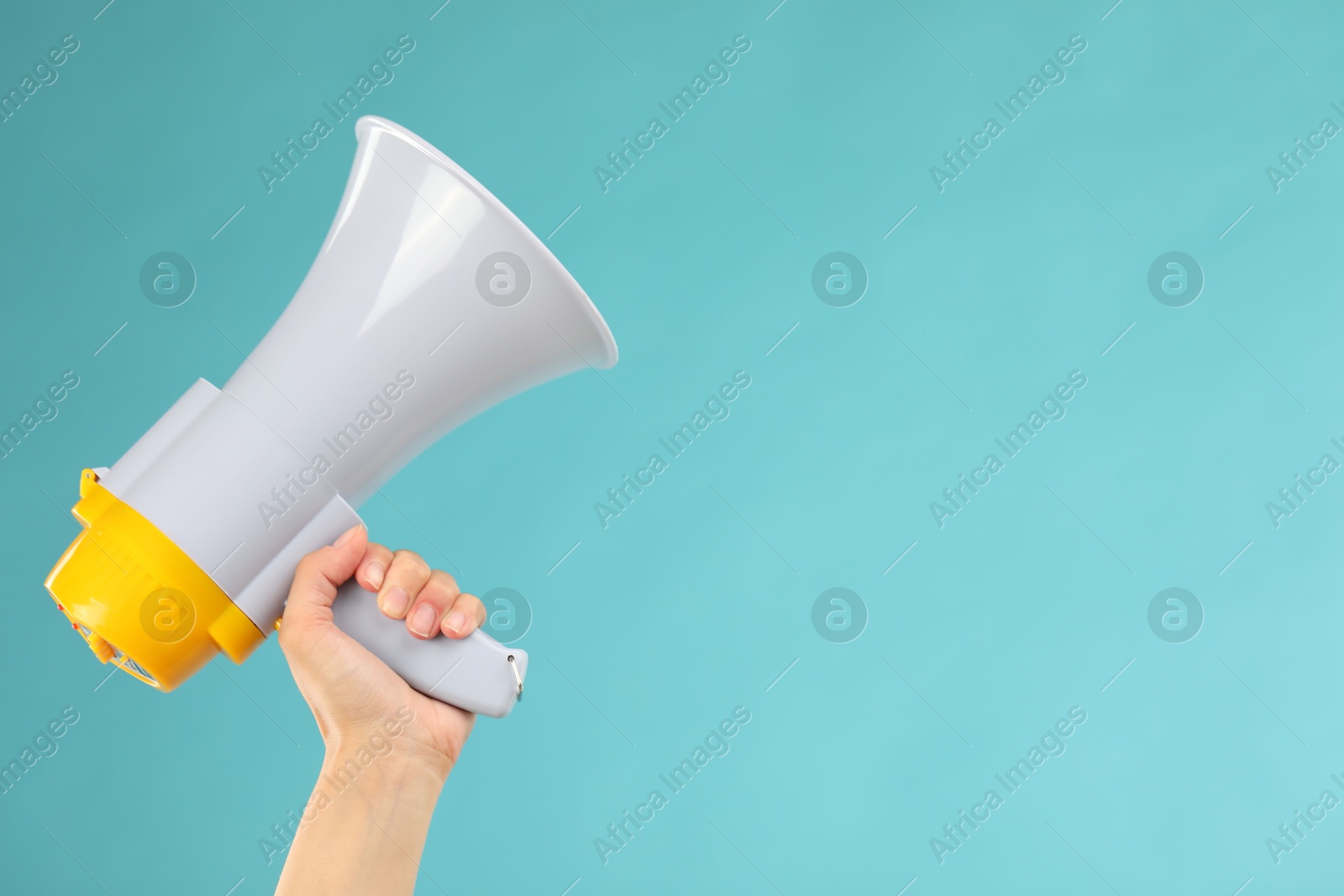 Photo of Woman holding megaphone speaker on blue background, closeup. Space for text