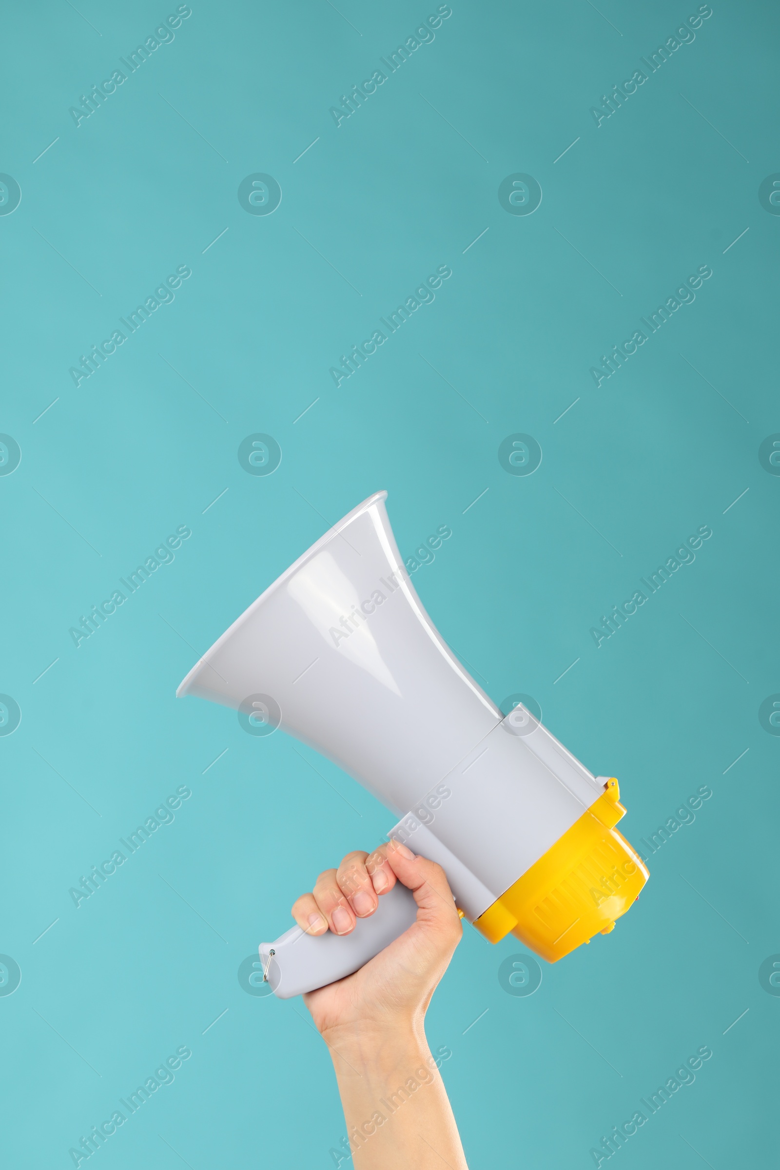 Photo of Woman holding megaphone speaker on blue background, closeup. Space for text