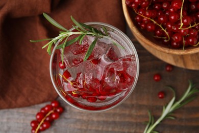 Refreshing water with red currants and rosemary in glass on table, flat lay