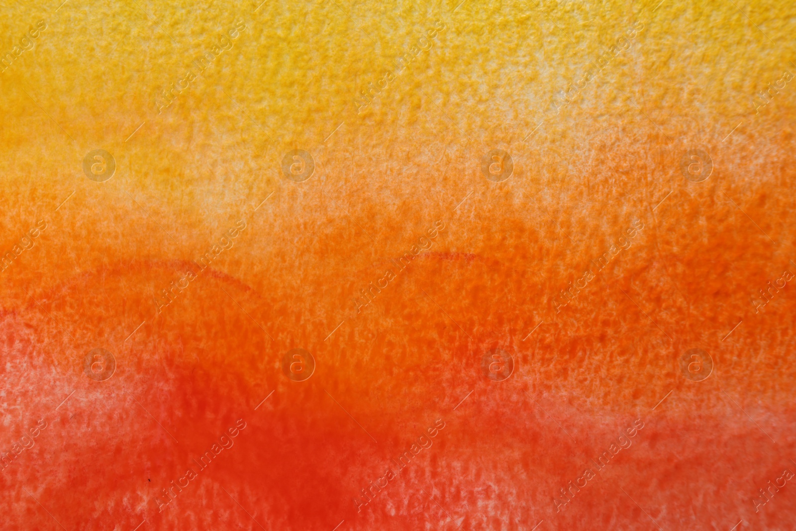 Photo of Orange watercolor painting on paper, top view