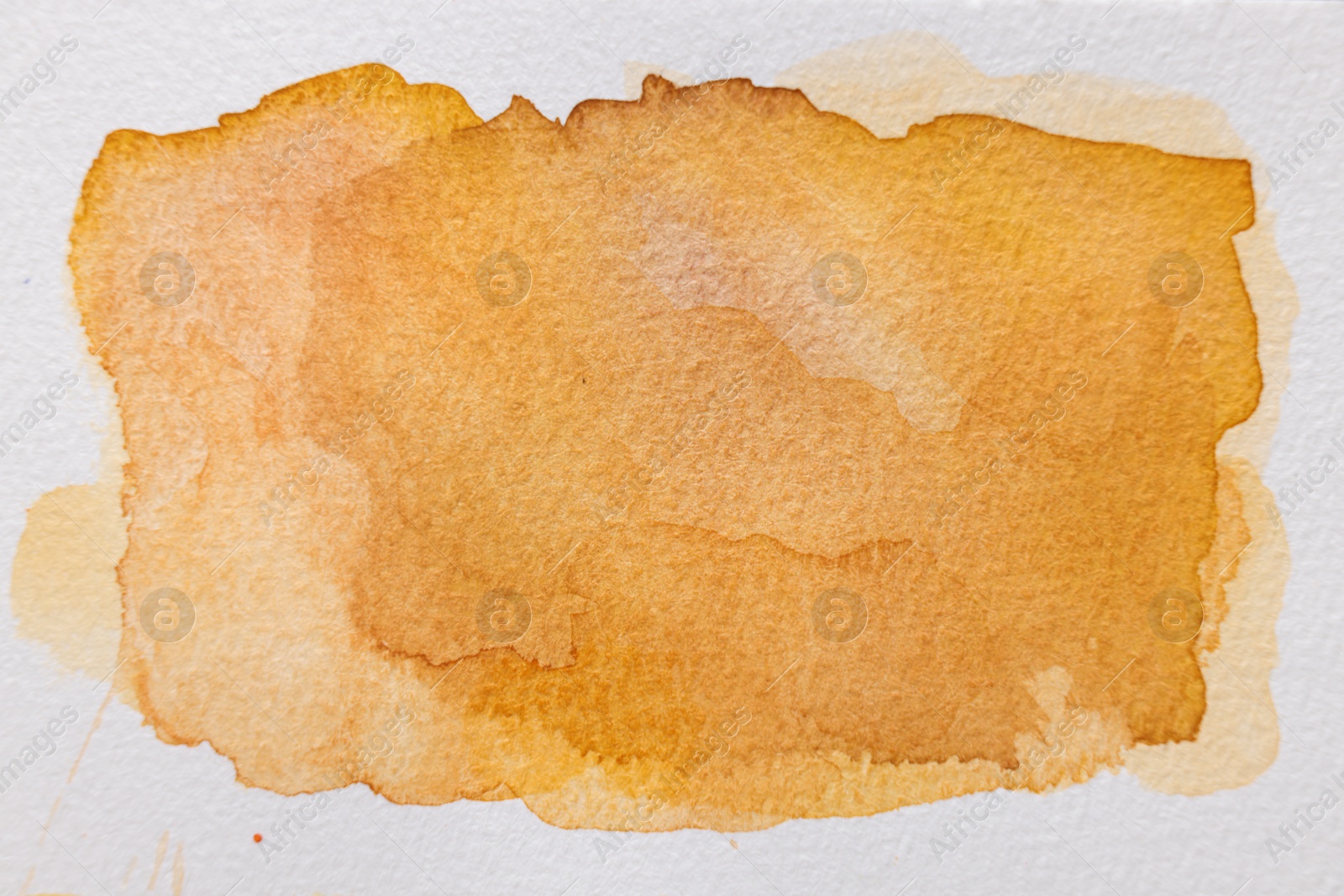 Photo of Orange watercolor painting on white paper, top view