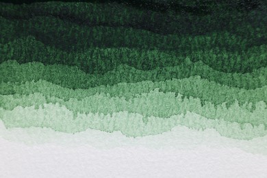 Photo of Green watercolor painting on white paper, top view