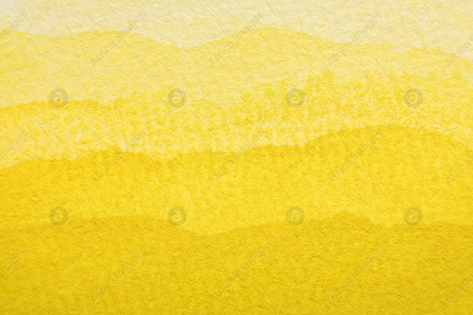 Photo of Yellow watercolor painting on paper, top view