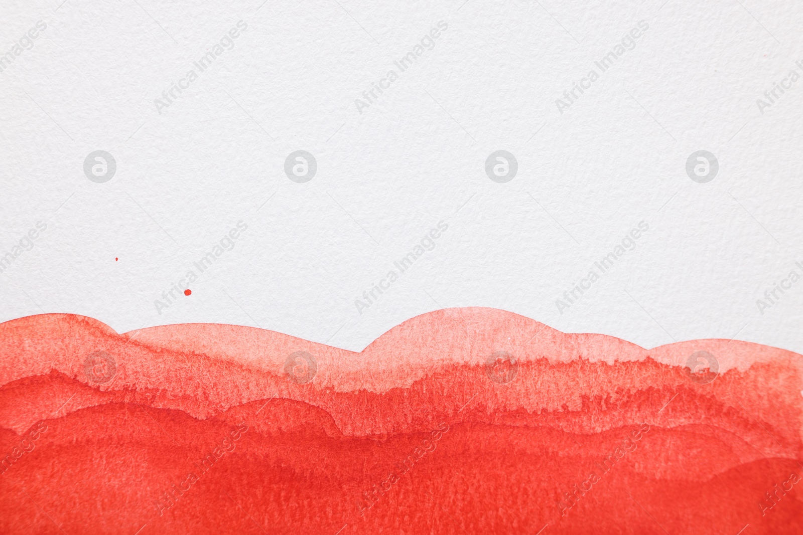 Photo of Red watercolor painting on white paper, top view. Space for text