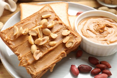 Photo of Delicious sandwich with peanut butter and fresh nuts on table, closeup