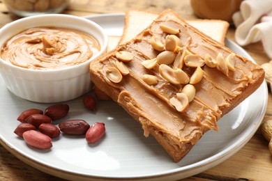 Photo of Delicious sandwich with peanut butter and fresh nuts on table, closeup