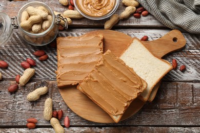 Photo of Delicious sandwiches with peanut butter and fresh nuts on wooden table, flat lay