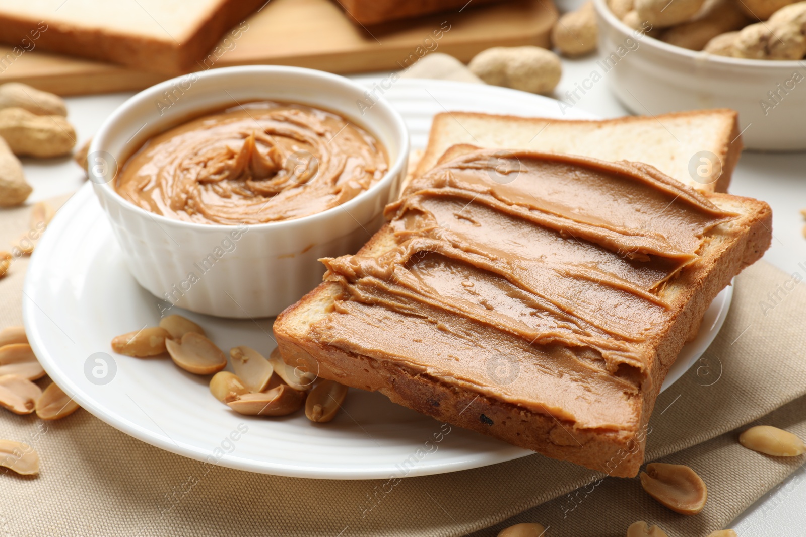 Photo of Delicious sandwich with peanut butter and fresh nuts on table, closeup