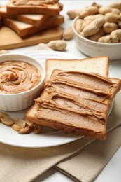 Photo of Delicious sandwich with peanut butter and fresh nuts on table, closeup