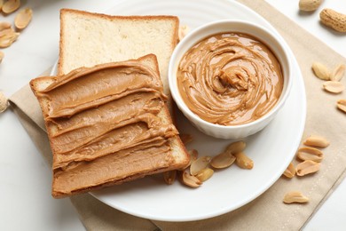 Photo of Delicious sandwich with peanut butter and fresh nuts on table, above view