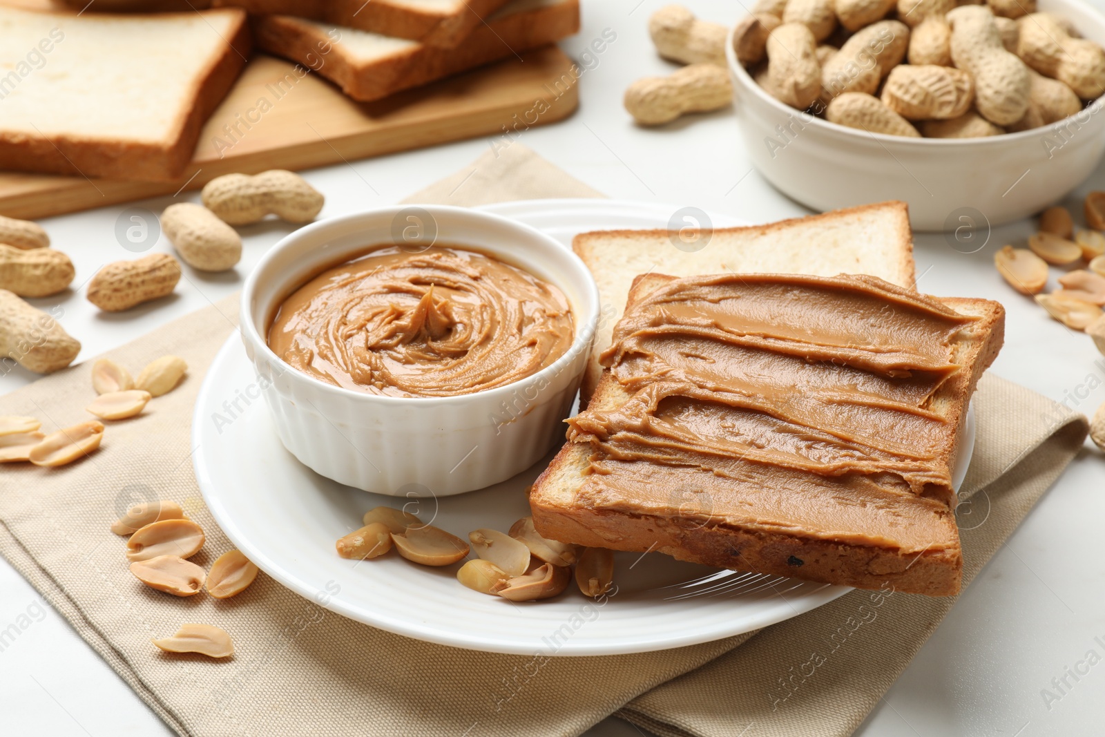 Photo of Delicious sandwich with peanut butter and fresh nuts on table, closeup