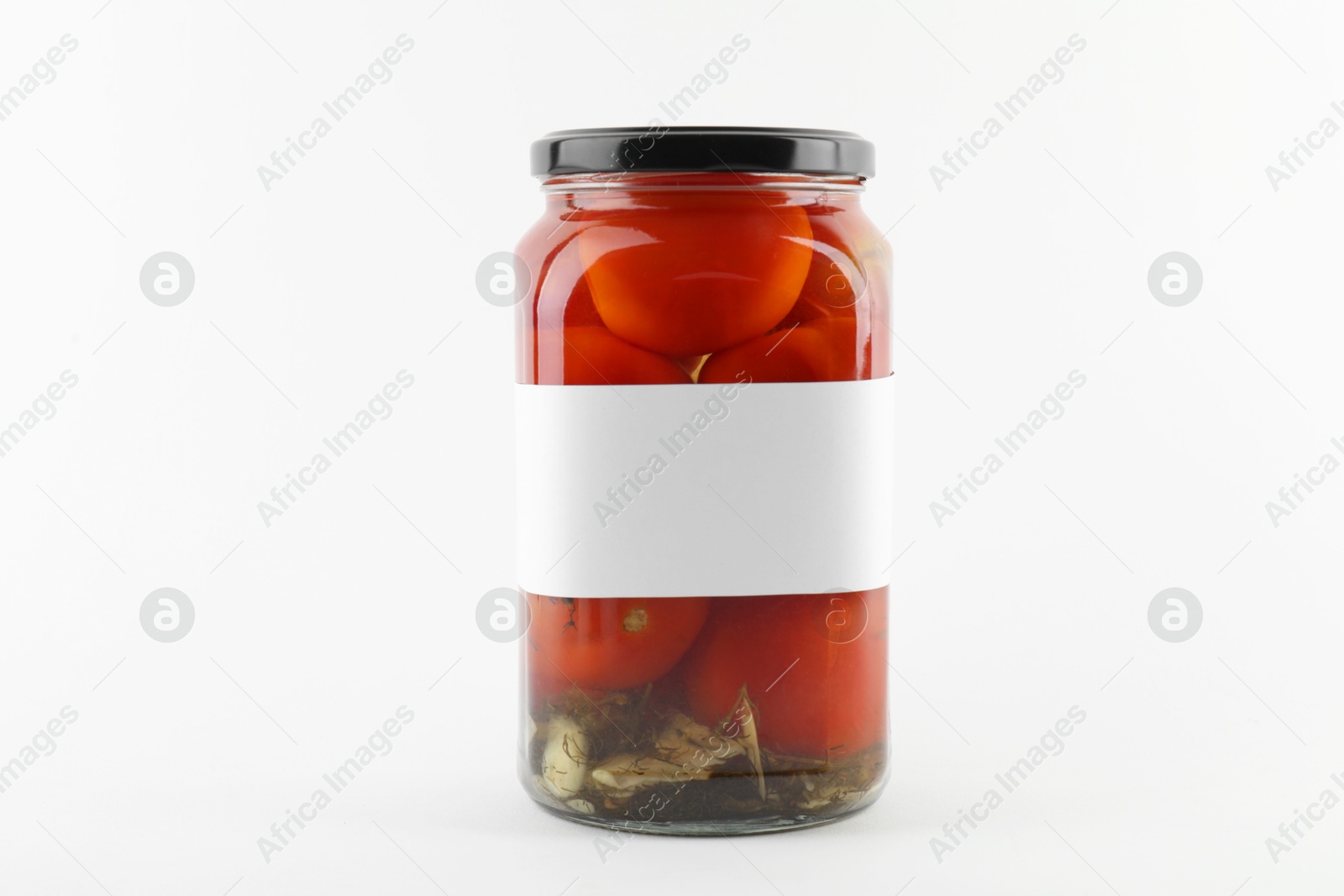 Photo of Tasty pickled tomatoes in jar on white background