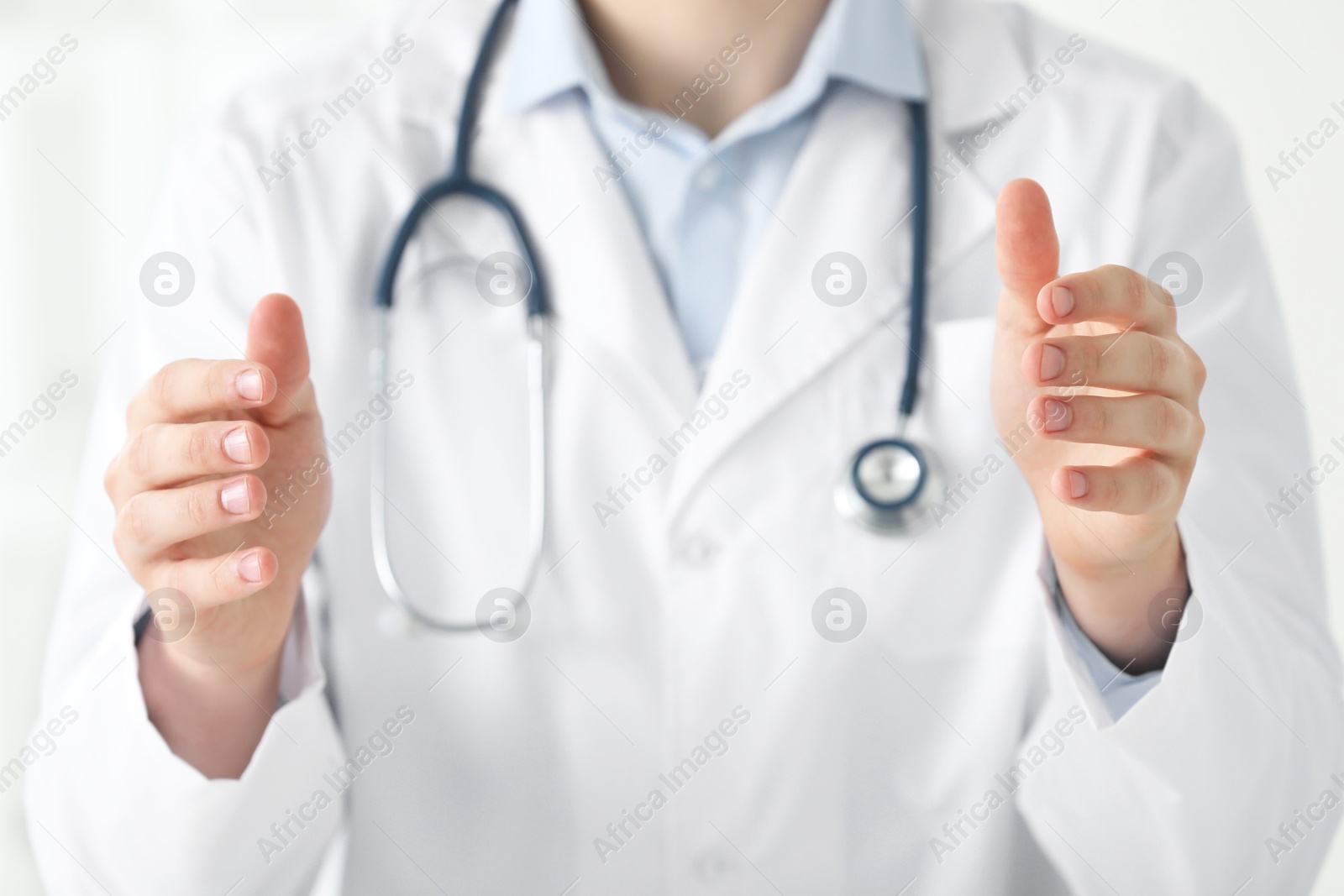 Photo of Doctor holding something in clinic, closeup view