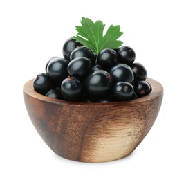 Photo of Bowl of ripe blackcurrants and green leaf isolated on white