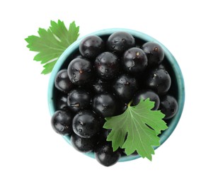 Photo of Fresh ripe black currant berries with leaves isolated on white, top view