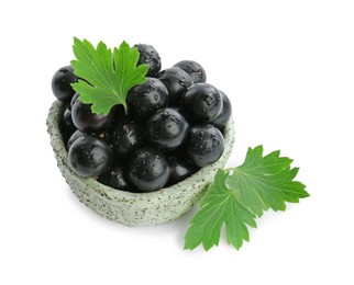 Fresh ripe black currant berries with leaves isolated on white